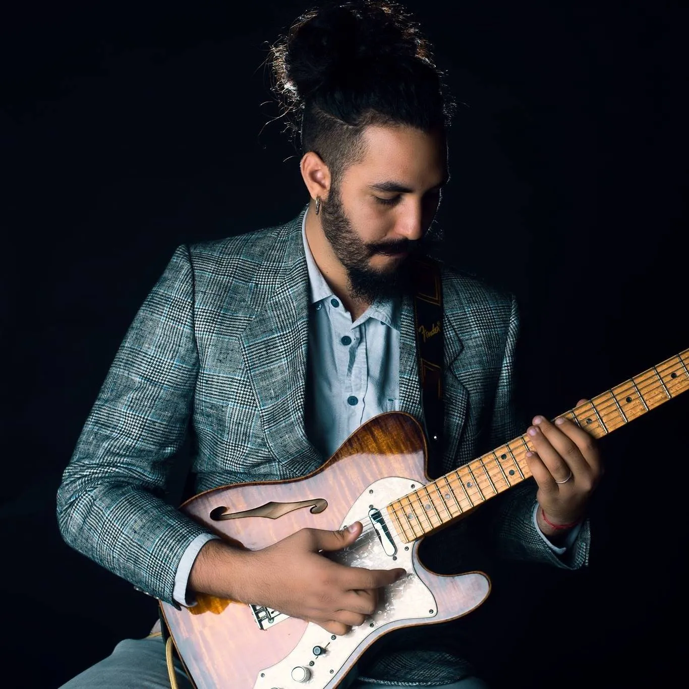 Ricky Castillo with his custom electric guitar in a color artist portrait