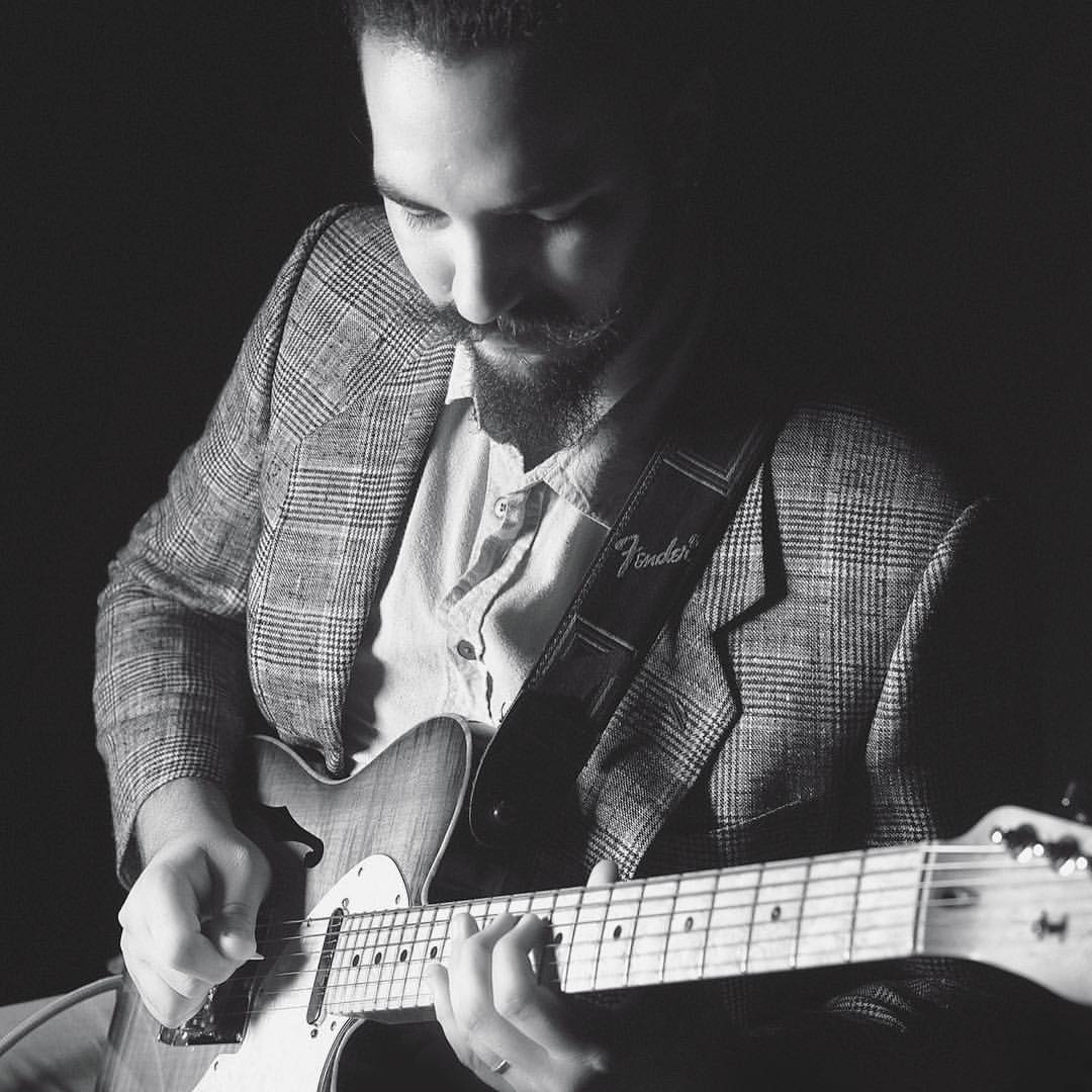 Ricky Castillo on stage playing jazz guitar