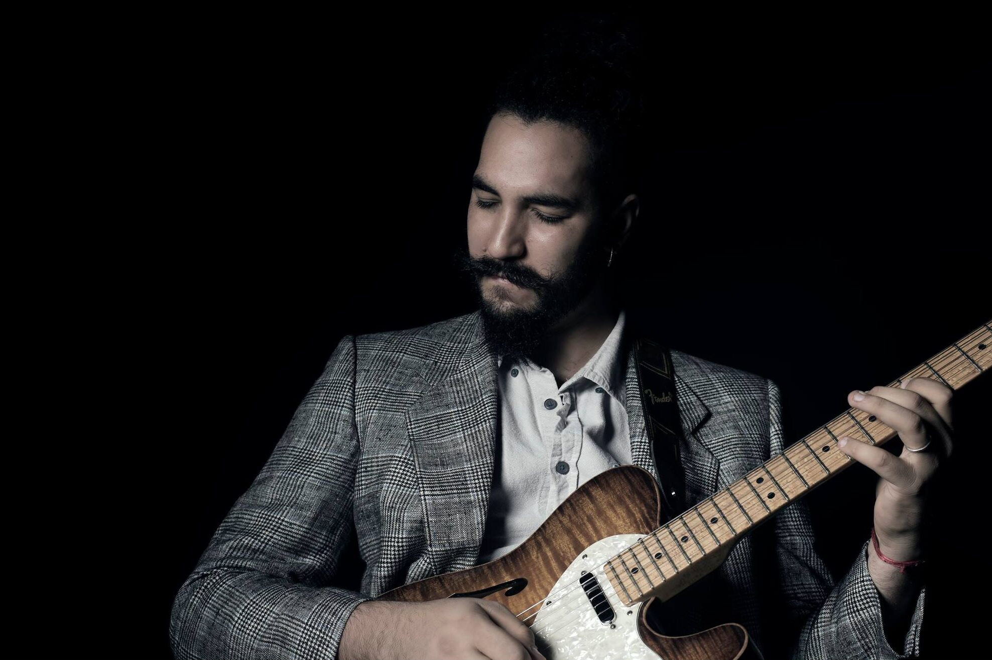 Ricky Castillo playing jazz guitar during a live performance